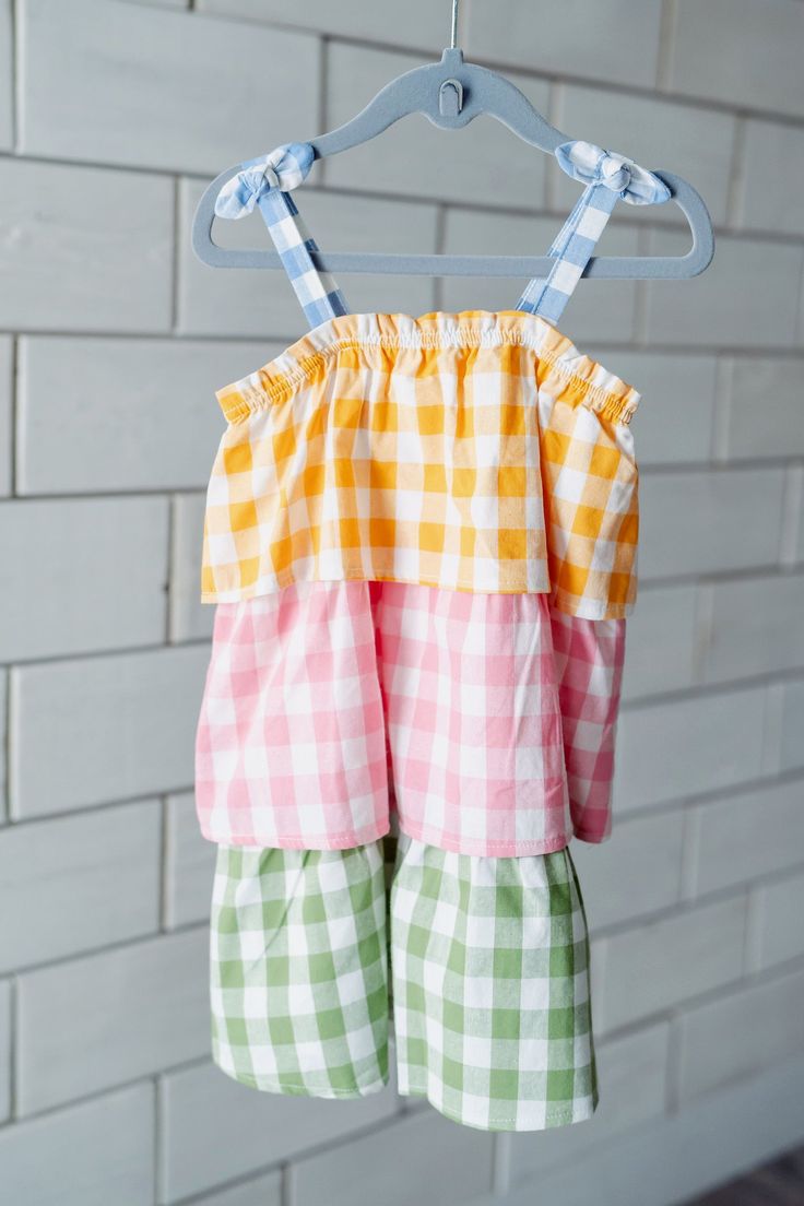 How darling is this Tiered Plaid Toddler Dress? The tiered ruffle flounce dress features bow spaghetti straps. The dress features color-block gingham patterns. The top features blue, followed by yellow, pink and green. This is the perfect springtime dress for playdates, school and more! Match little sister in our Mixed Check Pinafore Baby Set! Dress Features:Fabric: 100% CottonFit: True to SizeWashing Instructions: Turn Inside Out and Machine Wash Cold with Like Colors. Do Not Bleach. Tumble Dry Flounce Dress, Flounced Dress, Summer Ideas, Baby Set, Toddler Dress, Little Sisters, Baby Sets, Spring Time, Set Dress