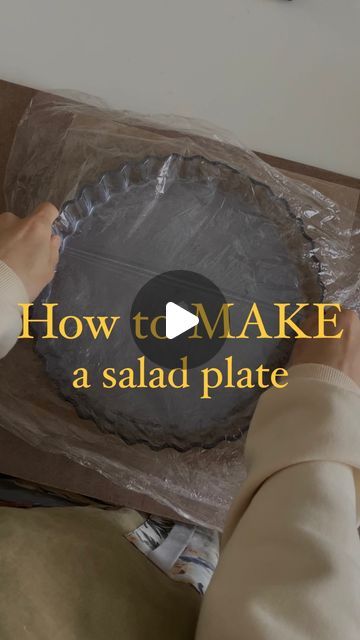 a person holding a cake in their hand with the words how to make a salad plate