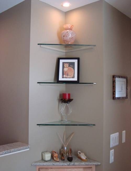 a shelf with some pictures and candles on it