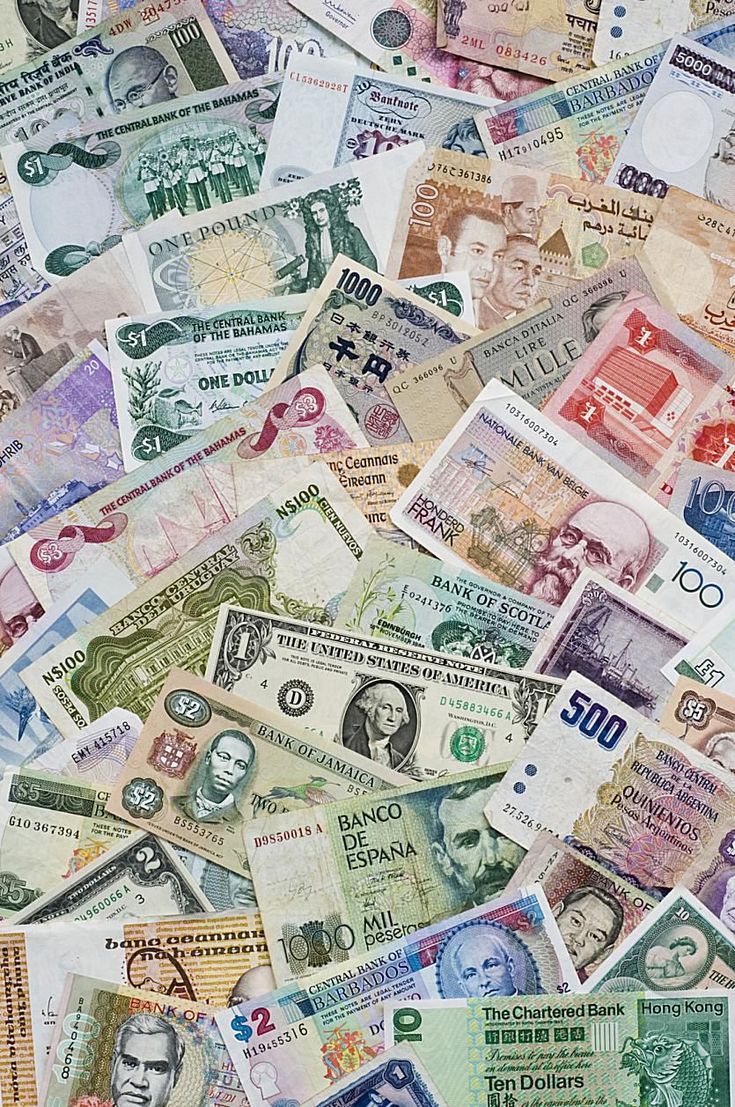 many different types of foreign currency are scattered on top of each other in this image