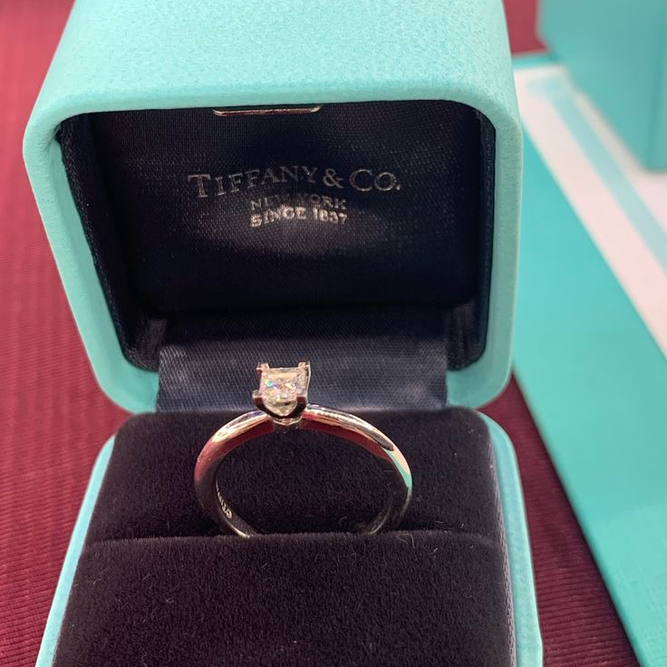 an engagement ring in a blue box