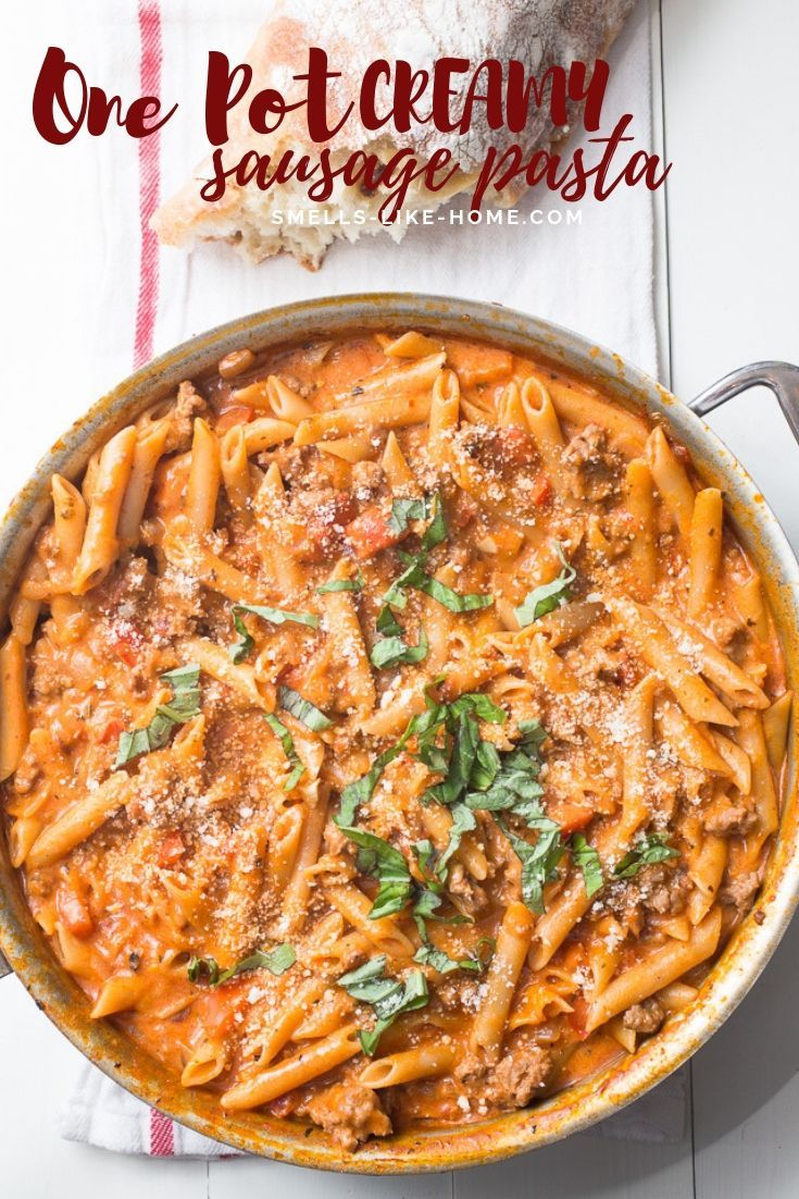 one - pot creamy sausage pasta with parmesan bread on the side and an empty baguette