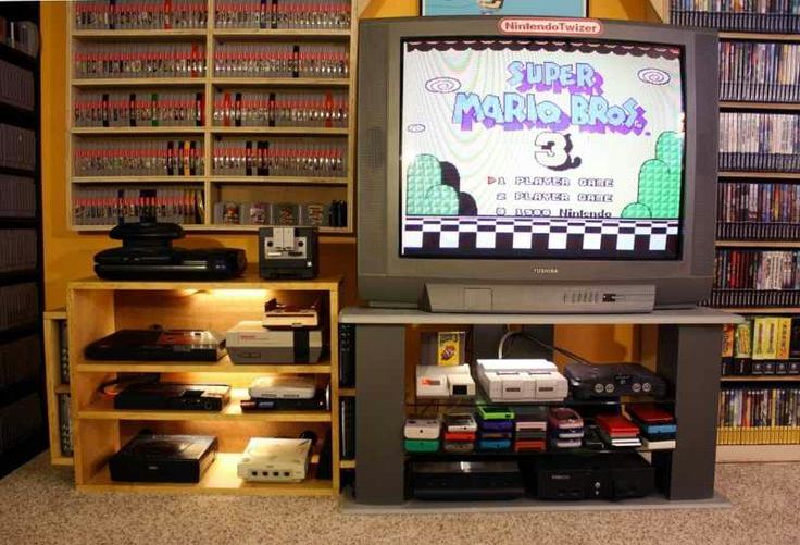 a television sitting on top of a wooden stand in front of a book shelf filled with books