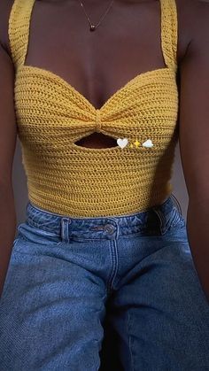 a close up of a person wearing jeans and a yellow top with a bow tie