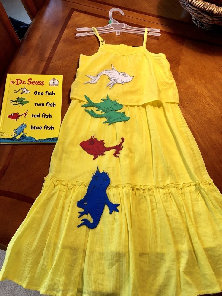 the dr seuss dress and book are sitting on a table next to each other