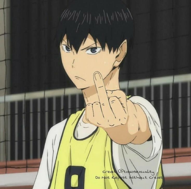 an anime character pointing to the side with his hand in front of him and wearing a yellow shirt