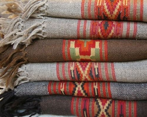 a pile of different colored rugs sitting next to each other