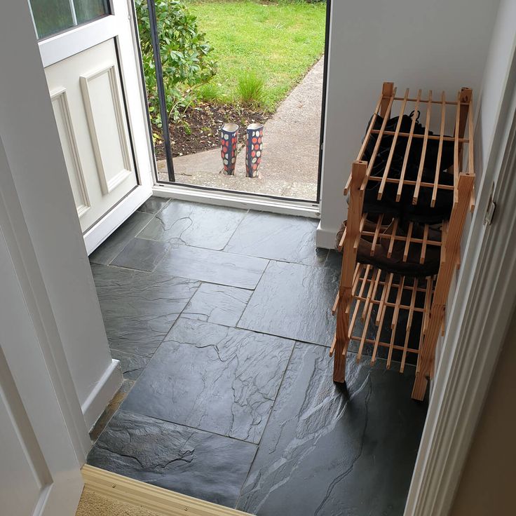 a wine rack sitting in the corner of a room next to a door with a glass window