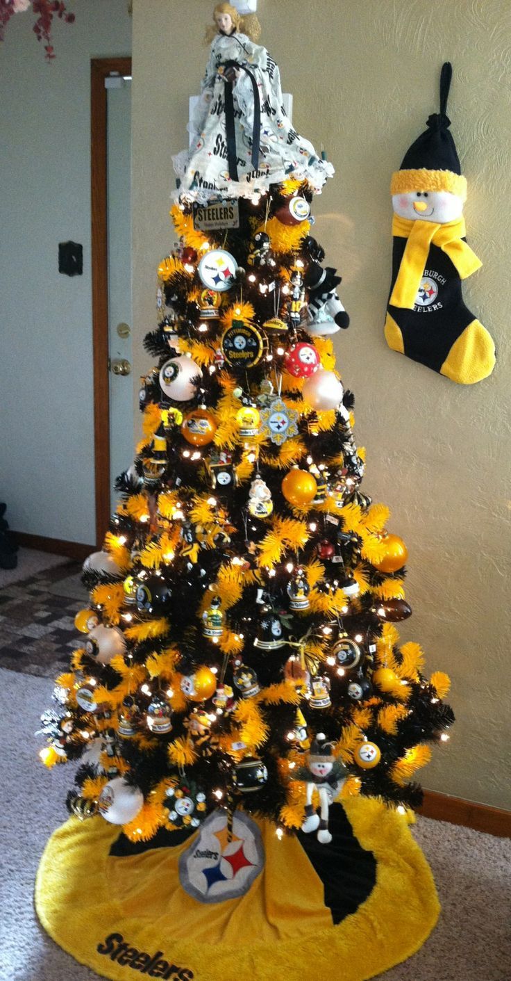 a yellow christmas tree with black and white decorations