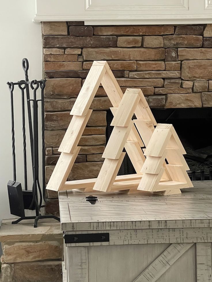 a wooden sculpture sitting on top of a table next to a fireplace