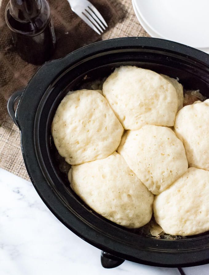 a black crock pot filled with bread on top of a table