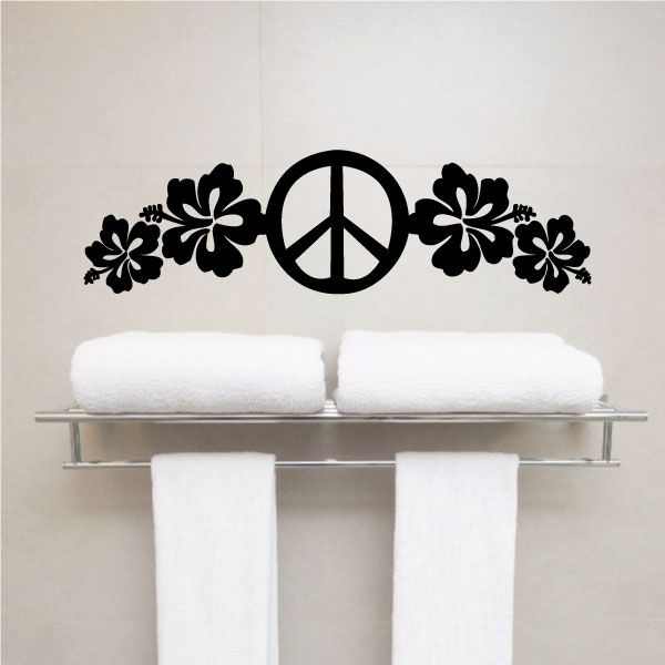 the peace sign is above two white towels on a rack in front of a wall