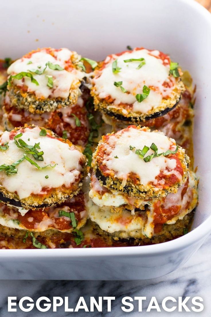 Stacks of baked eggplant, sauce, and ricotta in a large baking dish. Parmesan Tomatoes, Eggplant Recipes Healthy, Eggplant Stacks, Breaded Eggplant, Baked Eggplant Parmesan, Eggplant Rollatini, Eggplant Recipes Easy, Eggplant Parmesan Baked, Eggplant Recipes Parmesan