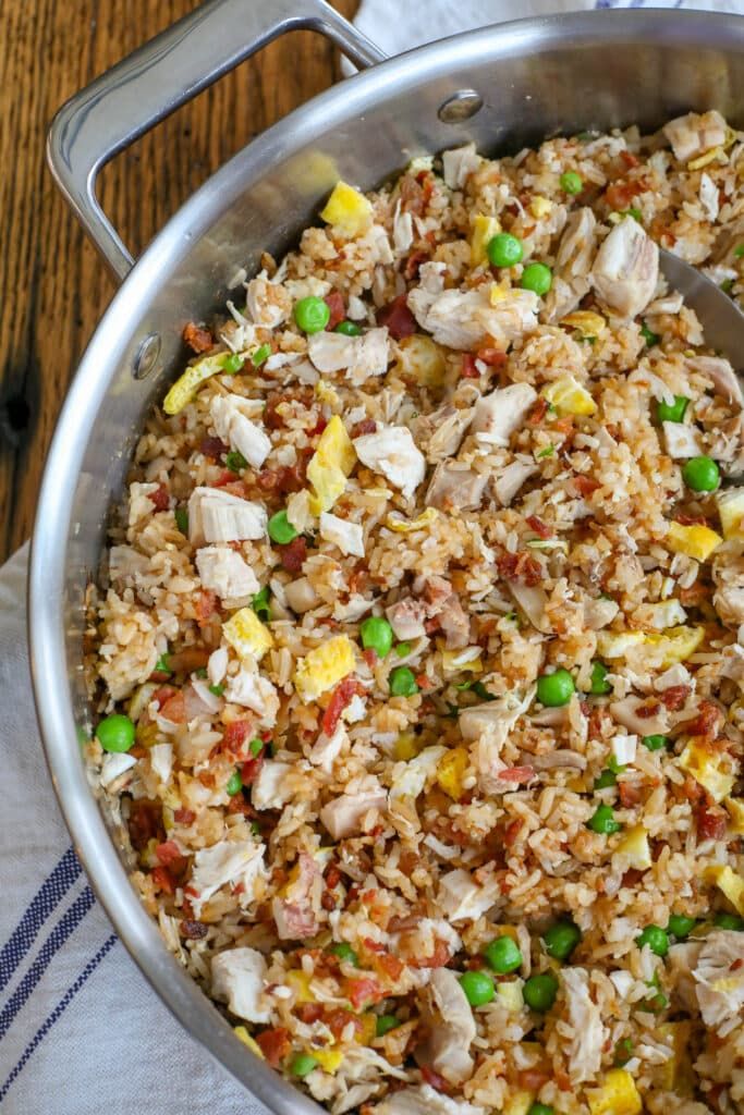 a pan filled with rice and peas on top of a table