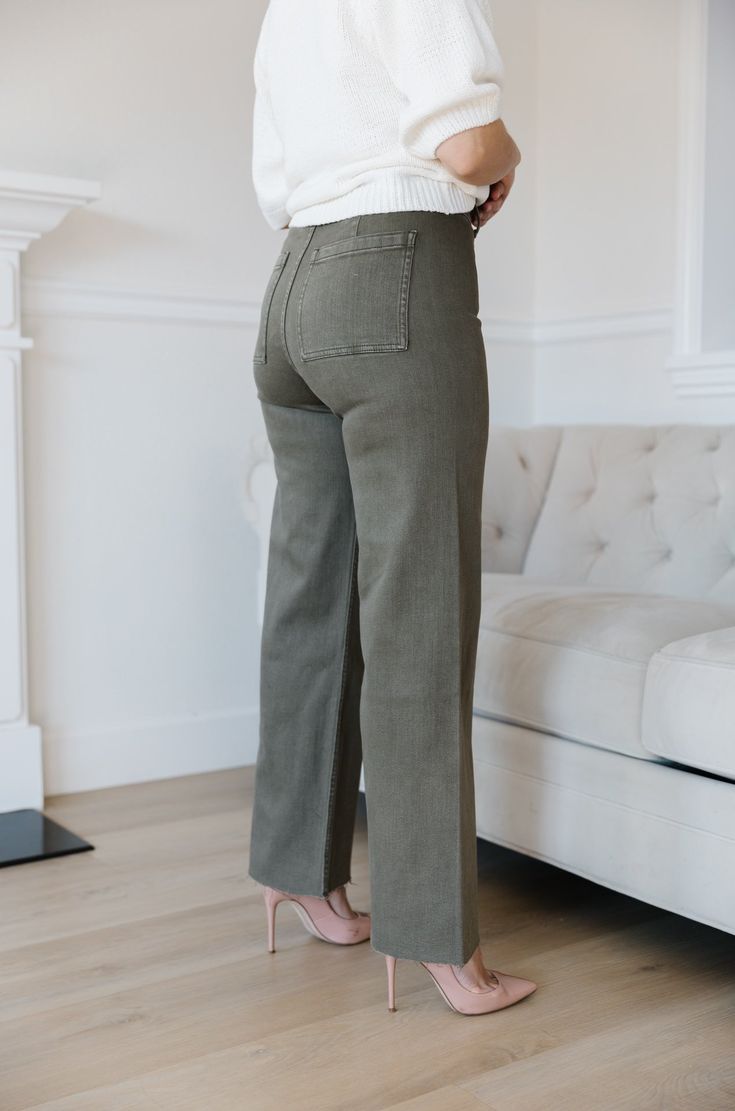 The Olive Green Wide Leg Jeans are an essential addition to any wardrobe. These classic jeans feature a flattering high waist, wide leg fit, and cropped style that flatters your figure and ensures comfort and flexibility throughout the day. Perfect for all seasons, these jeans provide timeless elegance and style. olive green wide leg pants high waist comfort stretch raw hem 98% cotton 2% spandex machine wash cold model is wearing a small SIZING CHART FOR THE JEANS: Small: fits sizing 25-26 Mediu Chic Straight Leg Flare Jeans, Versatile Full Length Jeans For Fall, Mid-rise Flare Jeans For Everyday In Fall, Versatile High Rise Wide Leg Pants For Spring, Trendy Wide Leg Pants For Everyday Fall Wear, Non-stretch Wide Leg Bottoms For Everyday, Versatile Wide Leg Jeans With Five Pockets, Mid-rise Wide Leg Pants For Everyday Fall Wear, Trendy Mid-rise Wide Leg Pants For Everyday