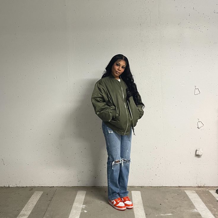 a woman standing in an empty parking lot