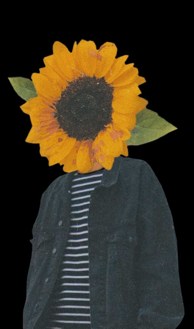 a sunflower is placed on top of a man's head in front of a black background