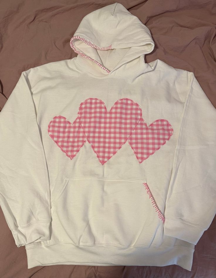 a white hoodie with pink hearts on the front and back in gingham