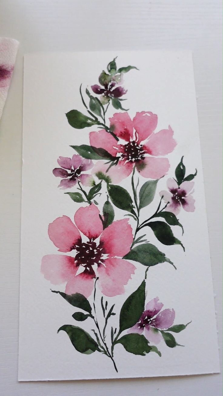 a watercolor painting of pink flowers on white paper