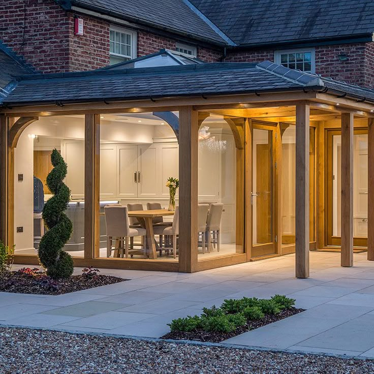 an outdoor dining area with patio furniture and lighting