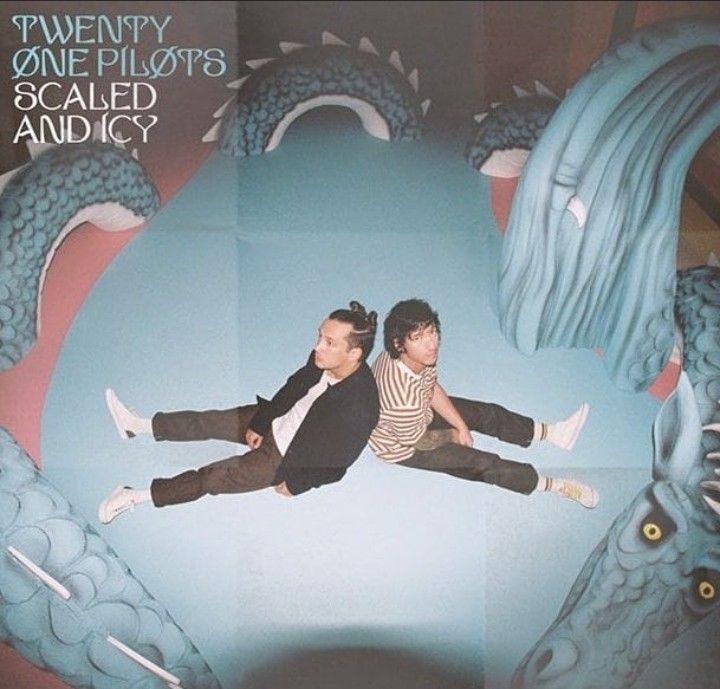 two people sitting on the back of a blue dragon painted mural with words twenty one pilots scalloped andic?