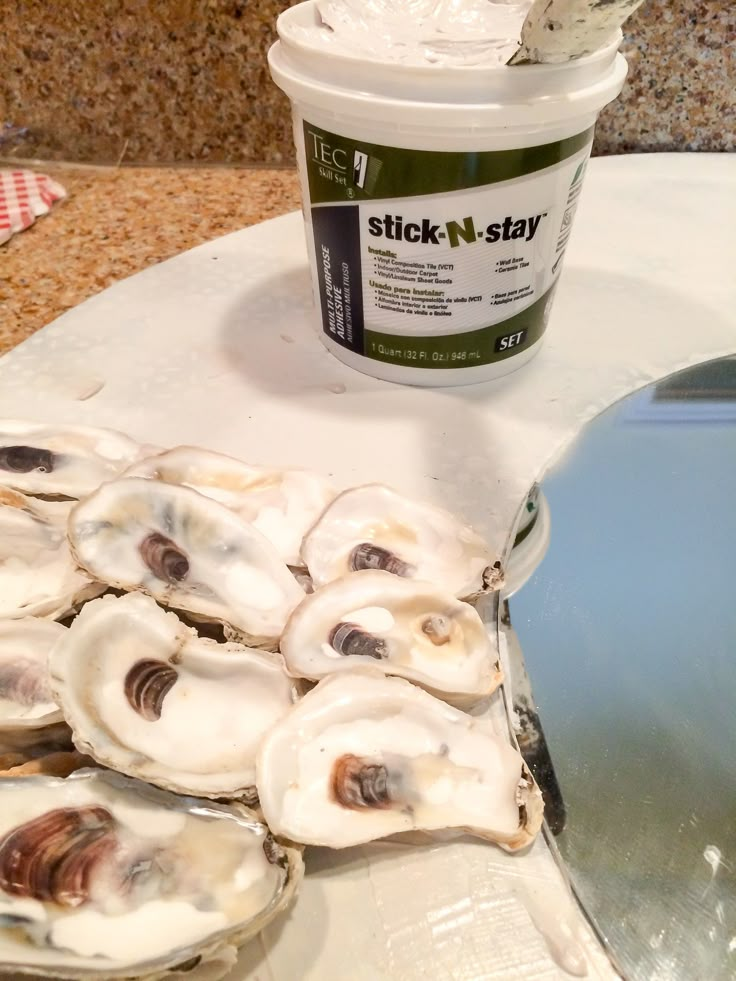 several oysters on a table next to a bucket of stick - n - stay