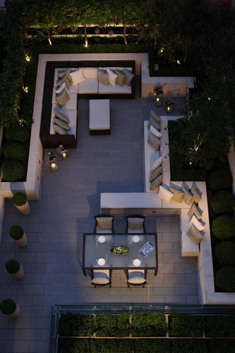 an aerial view of a patio and living room area with couches, tables, and chairs