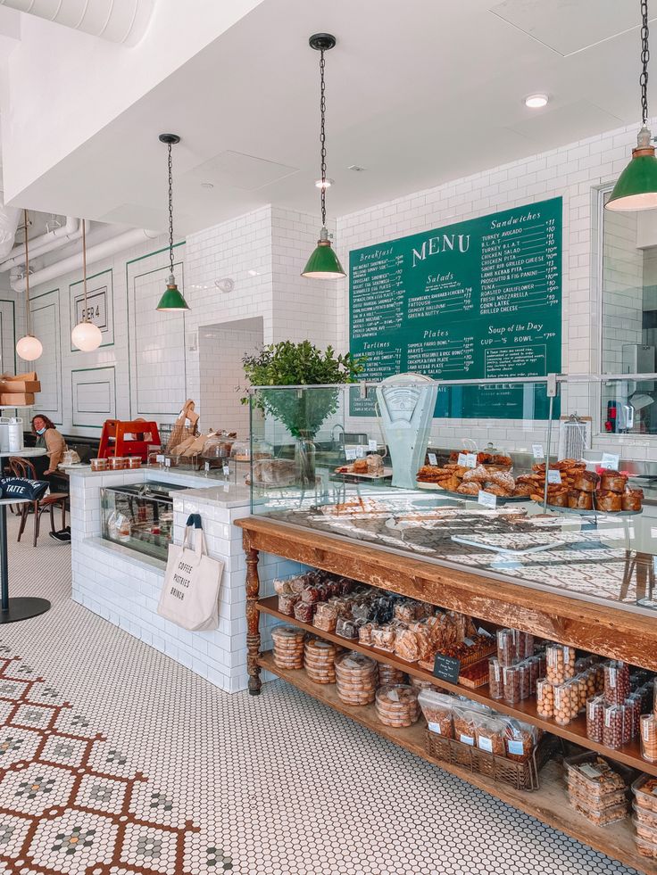 the inside of a bakery with lots of food on display