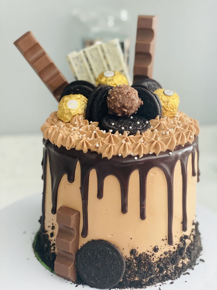 a cake decorated with chocolate, cookies and candy