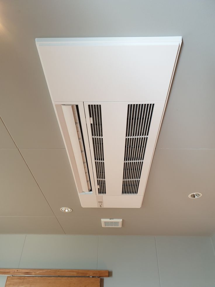 an air conditioner mounted on the side of a ceiling