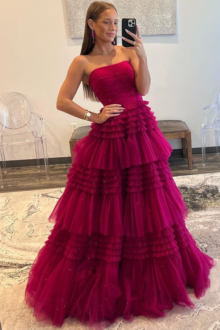 Rock this Peri-pleated, strapless tulle frock featuring tiers of ruffles, a built-in bra, and a zip-up back. Your full-length, dreamy-hued dress is perfect for a night of fun! Red Pink Prom Dress, Long Dance Dresses, Prom Dresses Fluffy, Layered Tulle Prom Dress, Fuchsia Prom Dress, Tiered Prom Dress, Tulle Long Prom Dress, Gown Prom Dresses, Off Shoulder Evening Dress