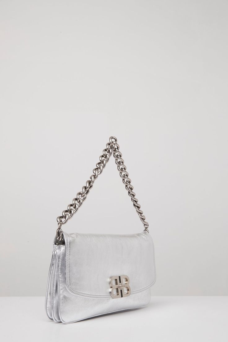 This bag from Balenciaga's Spring/Summer 2024 collection is in a silver peach calfskin with silver hardware. Leather Top Handle Bag With Silver-tone Logo Plaque, Leather Shoulder Bag With Silver-tone Logo For Everyday, Rectangular Leather Shoulder Bag With Silver-tone Logo, Modern Shoulder Bag With Silver-tone Logo Plaque, Evening Shoulder Bag With Silver-tone Logo, Silver Shoulder Bag With Top Handle And Silver-tone Logo, Chic Top Handle Bag With Silver-tone Logo Plaque, Silver Shoulder Bag With Silver-tone Logo For Formal Occasions, Silver Shoulder Bag With Silver-tone Logo For Formal Events