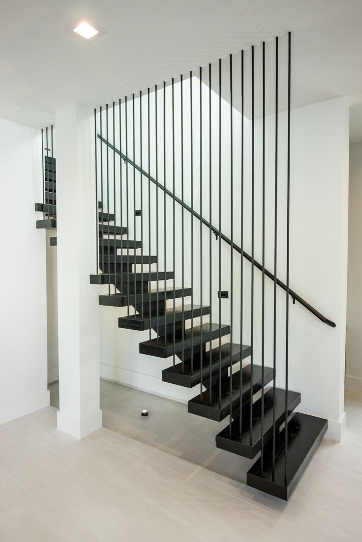 a black and white staircase in an empty room