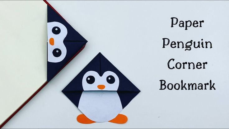 the penguin corner bookmark is next to an origami penguin