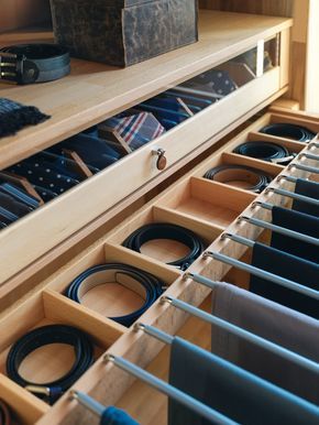 an organized drawer with ties in it