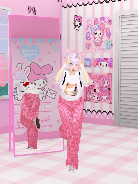 a woman in pink pants is walking through a room with hello kitty decorations on the walls