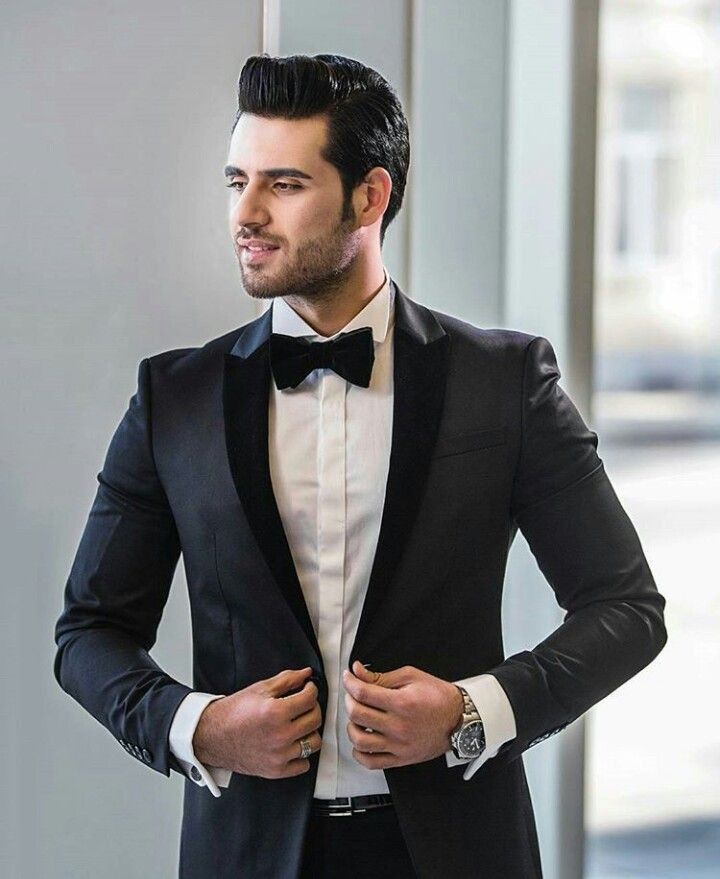 a man wearing a black tuxedo and bow tie