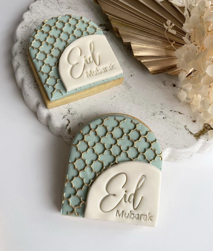 two decorated cookies sitting on top of a table