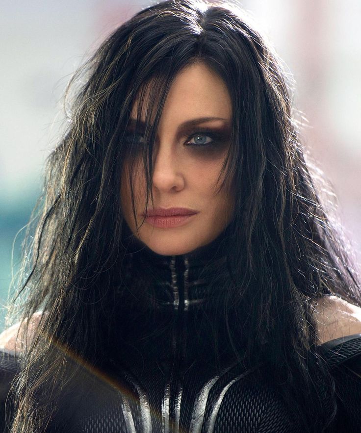 a close up of a person with long hair and black makeup wearing a catwoman costume