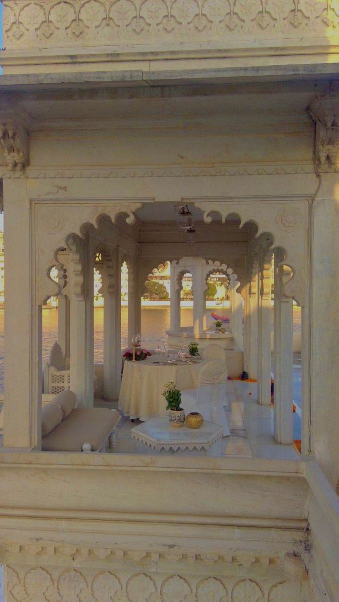 a white gazebo sitting on top of a lush green field