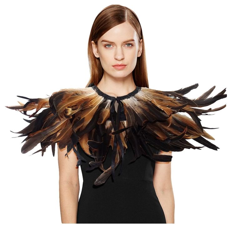 a woman wearing a black dress with brown feathers on it