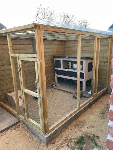 a chicken coop built into the side of a house with an oven on it's roof