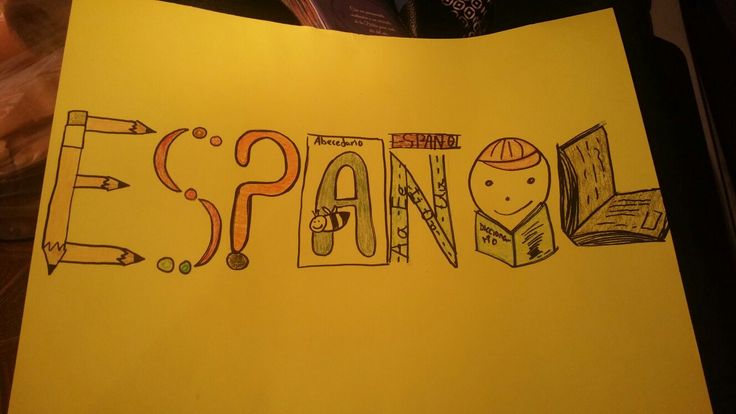 a yellow piece of paper with the word spain written in it and pencils on top