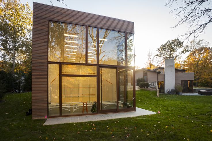 a modern house with large windows on the grass