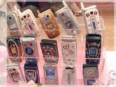 there are many cell phones on display in the case holder for each one's phone