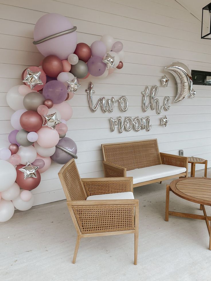 a room with balloons, chairs and tables on the outside wall that says you've got this moon