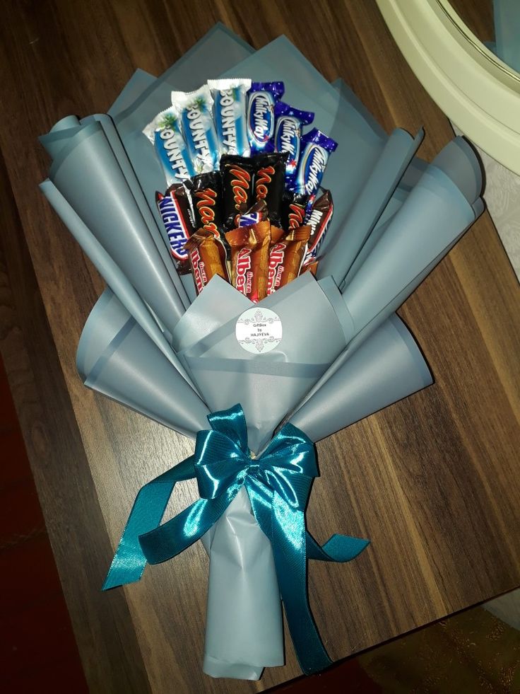 a bouquet of candy wrapped in blue paper