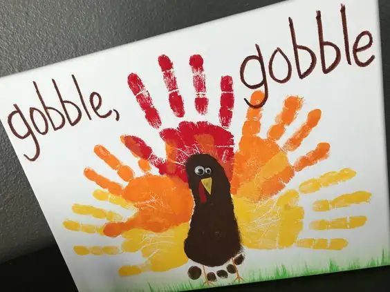 a handprint turkey with the words gobble gobble painted on it's side