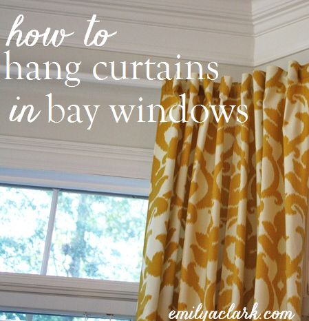 an orange and white curtain hanging in front of a window with the words how to hang curtains in bay windows