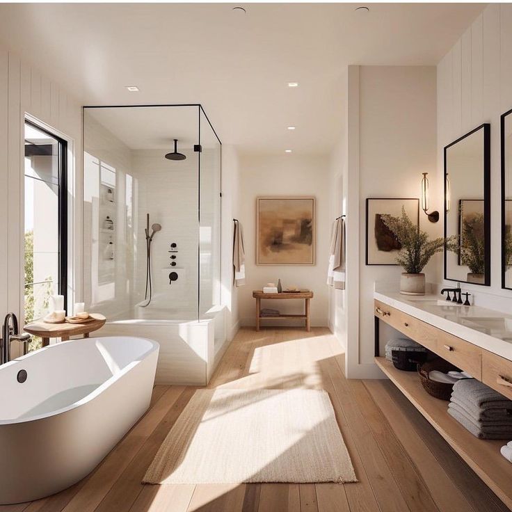 a large white bath tub sitting in a bathroom next to a walk in shower and sink